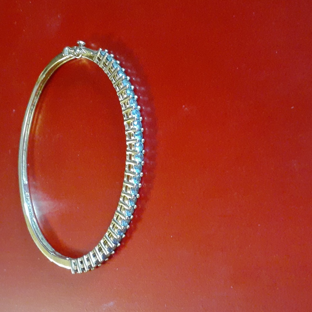 Vintage! 925 gold plated bangle bracelet with lite blue stones set in it